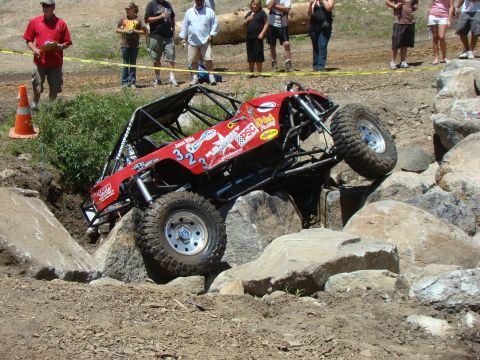 1989 Ford Bronco - A custom-built off-road buggy navigates a challenging rocky obstacle course.