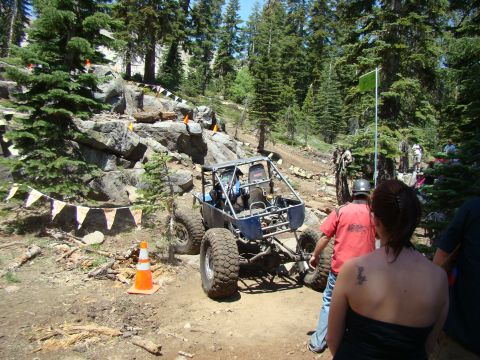 1989 Ford Bronco - A custom-built off-road buggy navigates a challenging course marked by flags and cones.