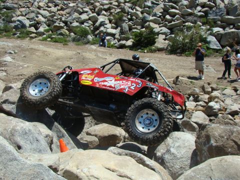 1989 Ford Bronco - Custom buggy navigates a challenging rocky terrain during an off-road event.