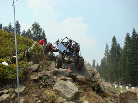 1989 Ford Bronco - Custom off-road buggy navigates a challenging rocky terrain during an event.