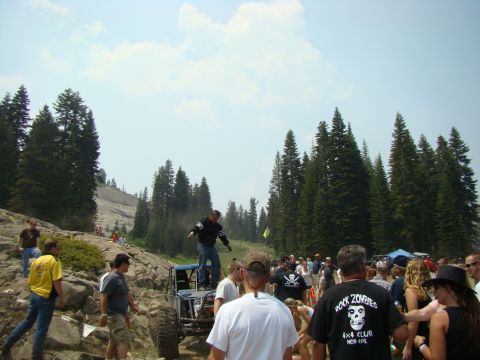 1989 Ford Bronco - A group of people watch an off-road buggy navigate a rocky terrain during an event.