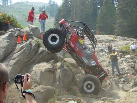 1989 Ford Bronco - A custom-built off-road buggy navigates a challenging rocky terrain during an event.