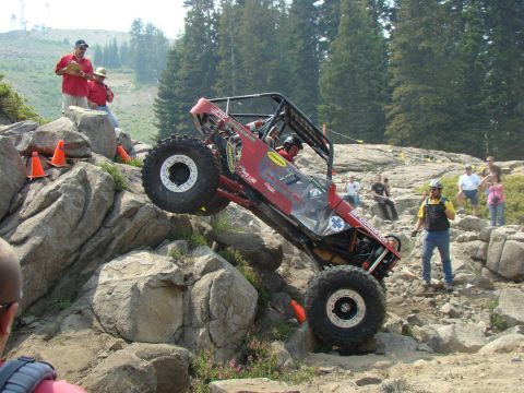 1989 Ford Bronco - Custom off-road buggy tackles a challenging rocky terrain during an event.