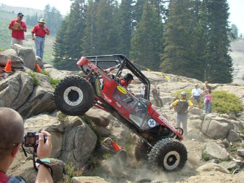 1989 Ford Bronco - A custom off-road buggy navigates a challenging rocky terrain during an event.