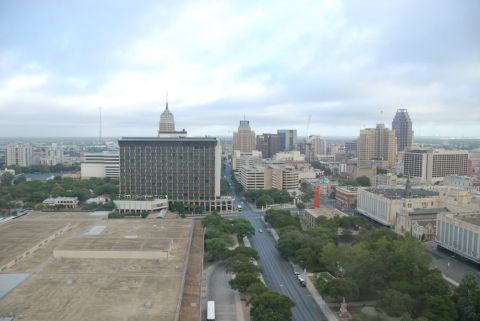 1996 Ford Bronco - A panoramic view of the San Antonio skyline, various architectural styles and lush greenery under an overcast sky.