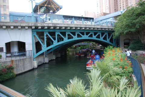 1996 Ford Bronco - Tour boats navigate the river beneath a bridge on a sunny day.