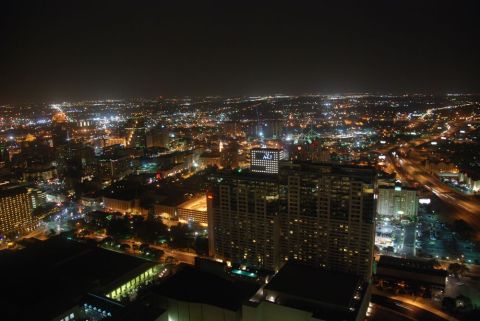 1996 Ford Bronco - A cityscape glows with lights under a dark night sky, urban development and infrastructure.
