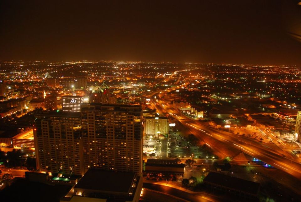 Cityscape at night with many lights and buildings
