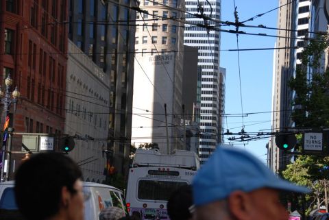 1996 Ford Bronco - A white bus with "ZERO EMISSIONS VEHICLE" text is seen from the rear in a city street scene.