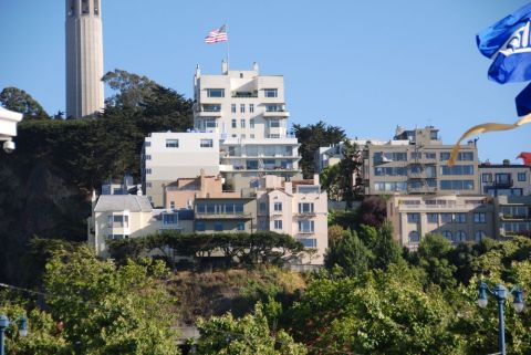 1996 Ford Bronco - Coit Tower stands tall over the cityscape of San Francisco, with trees in the foreground.