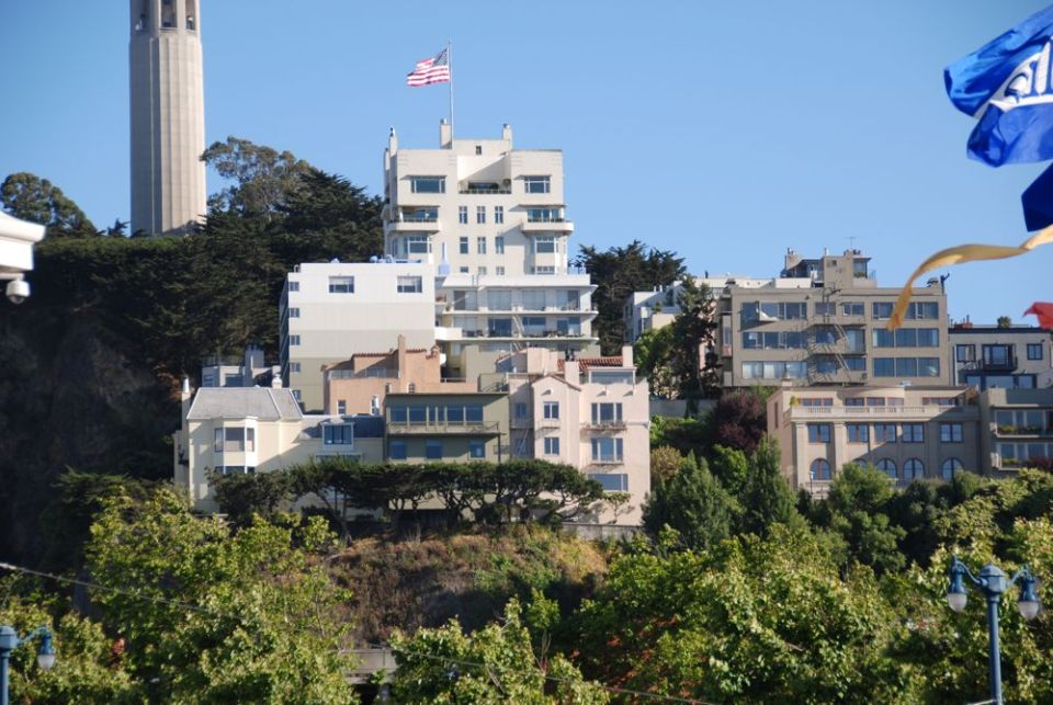 View of San Francisco buildings, including Coit Tower, on a sunny day