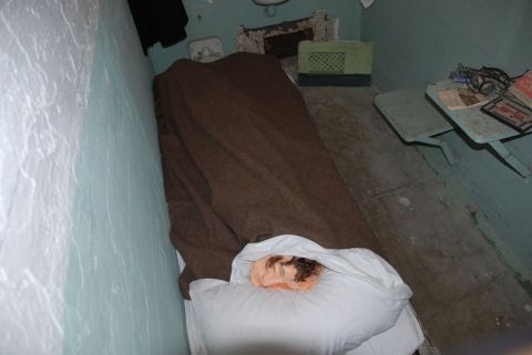 1996 Ford Bronco - A staged scene depicts a prison cell with a bed, a blanket, and a dummy head resting on a pillow.