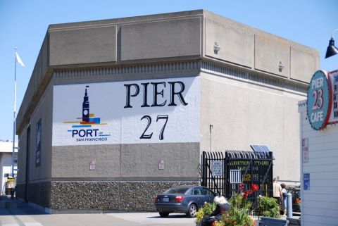1996 Ford Bronco - A dark sedan is parked in front of the Pier 27 building in San Francisco.