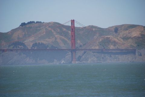 1996 Ford Bronco - The iconic Golden Gate Bridge stands tall against a backdrop of hazy hills and blue sky.