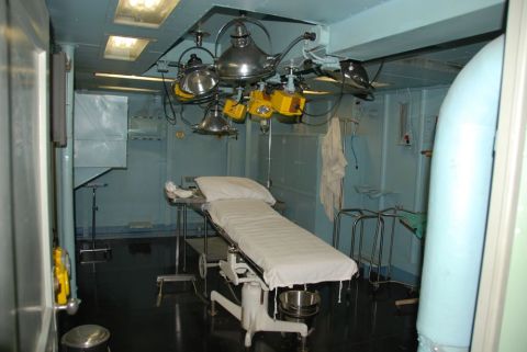 1996 Ford Bronco - This is a scene of an operating room, complete with a patient bed and overhead surgical lights.