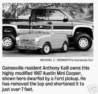 1991 Ford Crown Victoria - A 1967 Austin Mini Cooper is dwarfed by a Ford pickup truck in this photo.