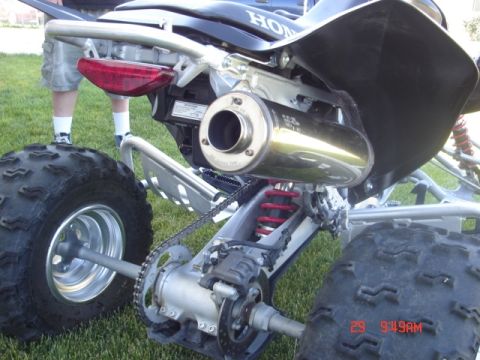 1981 Ford Bronco - Rear view of an ATV showing its exhaust pipe, suspension, and tire.