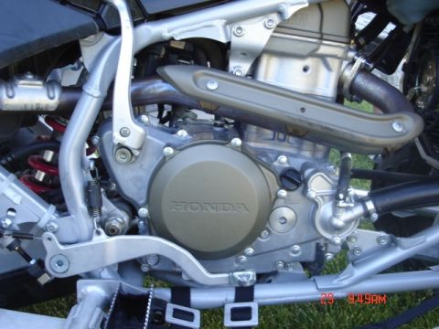 1981 Ford Bronco - Close-up view of the engine on a Honda TRX450R, highlighting the "HONDA" logo on the crankcase cover.