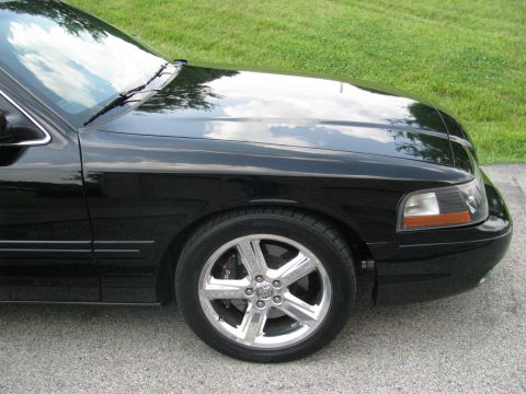 2003 Mercury Marauder - Front quarter view of a black 2003 Mercury Marauder showing the fender, wheel, and headlight.