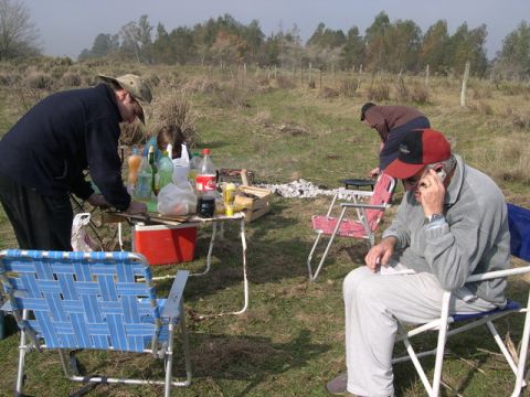 1996 Ford Explorer - A group of people enjoy a casual outdoor gathering with food and drinks spread across a table.