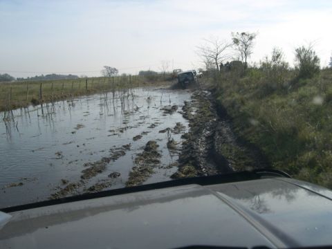 1996 Ford Explorer - Multiple SUVs navigate a challenging muddy and flooded off-road course.