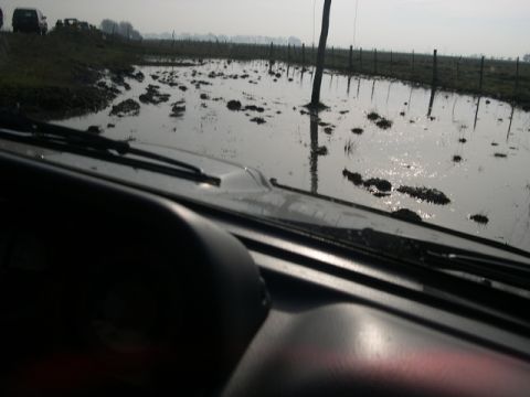 1996 Ford Explorer - Driving through a flooded field, with two other vehicles visible in the distance.