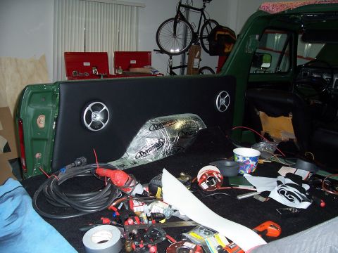 1978 Ford Bronco - The interior of a green vehicle is being worked on, with sound dampening and speakers installed.
