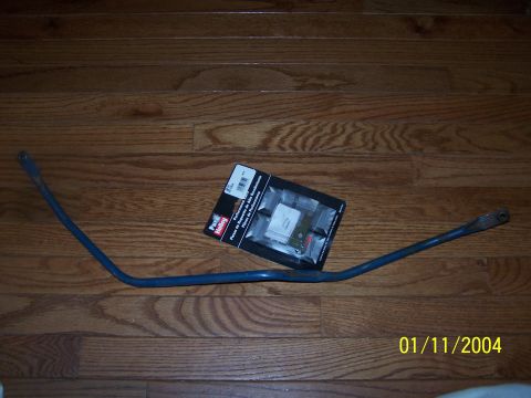 1979 Ford F-150 - A blue metal bar and a package of Pure Holley Performance Parts are displayed on a wooden floor.