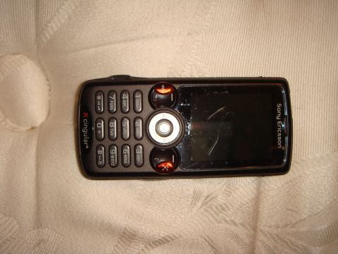 1992 Ford Bronco - A black Sony Ericsson phone with a keypad and screen is shown on a light-colored, textured background.