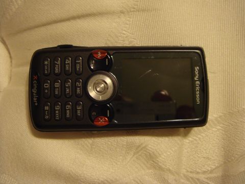 1992 Ford Bronco - A black Sony Ericsson mobile phone is shown from a top-down perspective on a textured background.