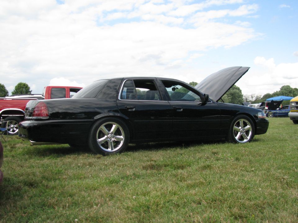 Black 2003 Mercury Marauder with hood open, parked on grass