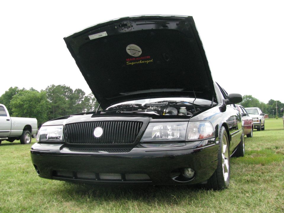 Black 2003 Mercury Marauder front view, hood open, showing "Marauder Supercharged" emblem
