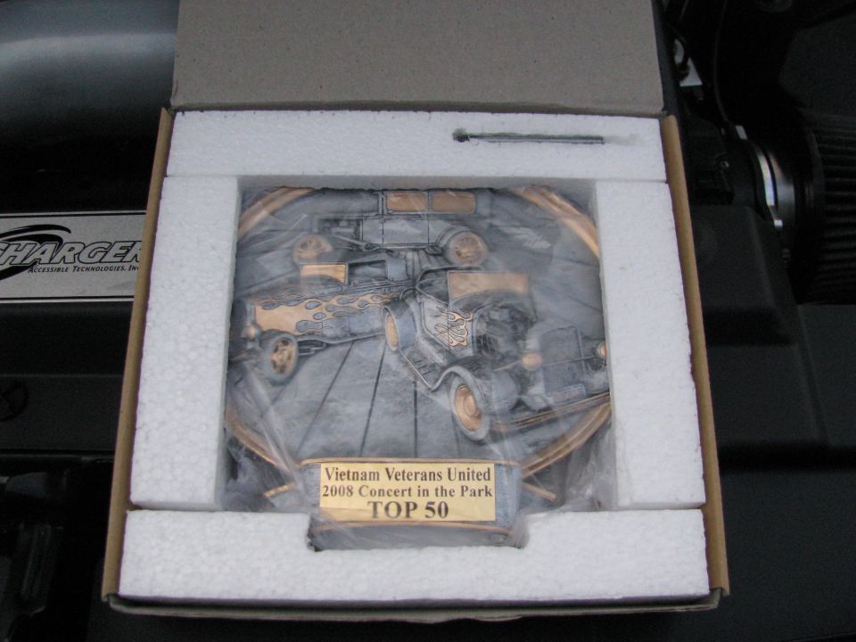 Commemorative plate depicting vintage trucks, inside a box with foam padding