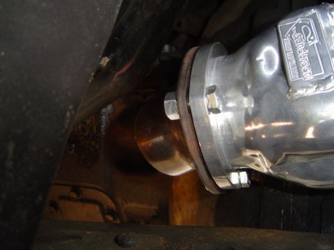 1978 Ford Bronco - Close-up of an aftermarket exhaust pipe with a Sanderson logo, attached to a vehicle's undercarriage.