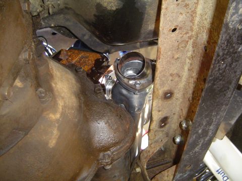 1978 Ford Bronco - Close-up view of a newly installed exhaust pipe connection, showing the shiny metalwork and fasteners.