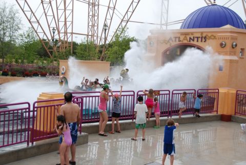 1996 Ford Bronco - People enjoy a splashing water ride at an amusement park with the "Journey to Atlantis" attraction.