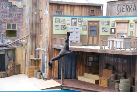 1996 Ford Bronco - A sea lion performs in front of a backdrop designed to look like a western town, complete with signs for 'OFFICE' and 'PORTOLA'.