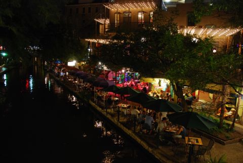 1996 Ford Bronco - Nighttime view of the San Antonio Riverwalk, with illuminated buildings and outdoor dining areas.