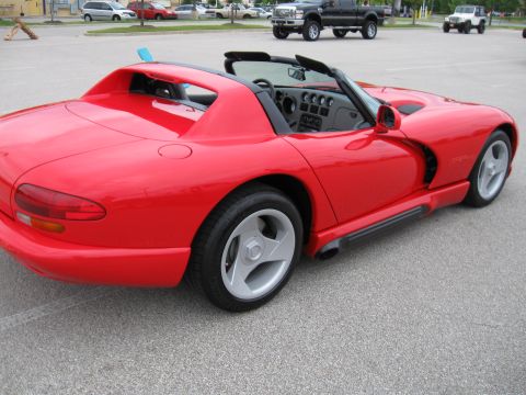 1994 Ford Bronco - Red convertible sports car with a unique body style, possibly a first-generation Dodge Viper.
