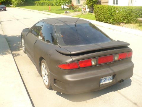 1993 Ford Probe - This 1993 Ford Probe is seen from the rear, a dark matte paint job and a spoiler.