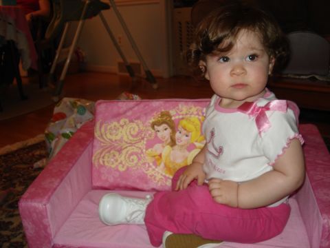 2000 Ford Crown Victoria - Toddler sits on a pink couch with princess characters on the back cushion.