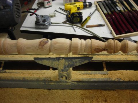 1995 Ford Bronco - Woodworking lathe with a partially turned wooden spindle and various tools on a workbench.