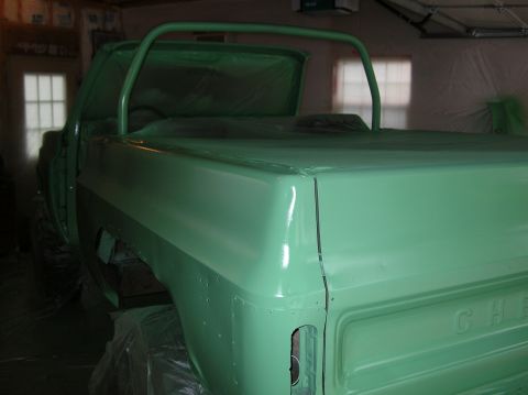 1975 Chevrolet Blazer - This 1975 Chevrolet Blazer is undergoing a paint job in a garage, showing its rear quarter panel and bed.