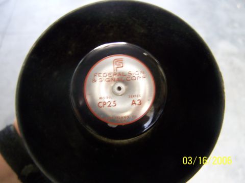 1998 Ford Crown Victoria - Close-up of a Federal Signal & Signal Corp CP25 siren speaker, dated 03/16/2006.