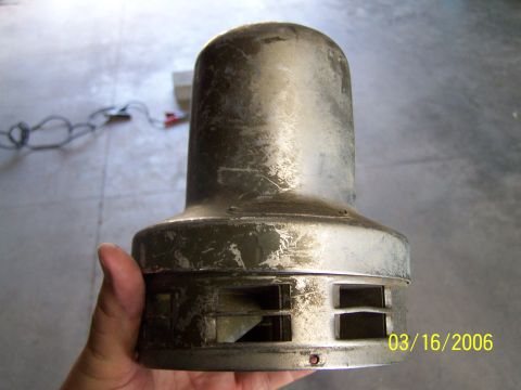 1998 Ford Crown Victoria - A metal part with vents is held in a hand, with a date stamp of 03/16/2006 visible.