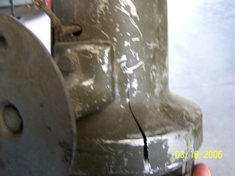 1998 Ford Crown Victoria - This close-up shows a damaged metal part with a visible crack and peeling paint, dated 03/16/2006.
