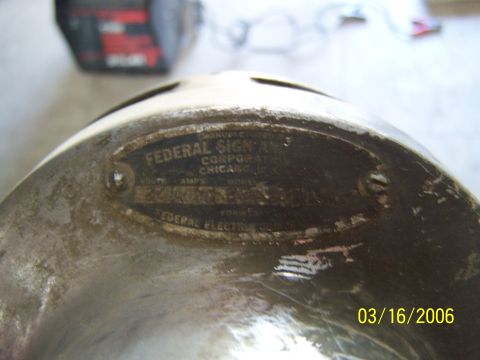 1998 Ford Crown Victoria - A close-up view of a metal component displaying a "Federal Sign & Signal Corporation" manufacturer's plate, indicating its origin in Chicag…