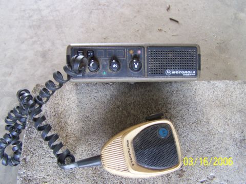 1998 Ford Crown Victoria - Motorola MOSTAR radio and microphone set, photographed on a concrete surface.