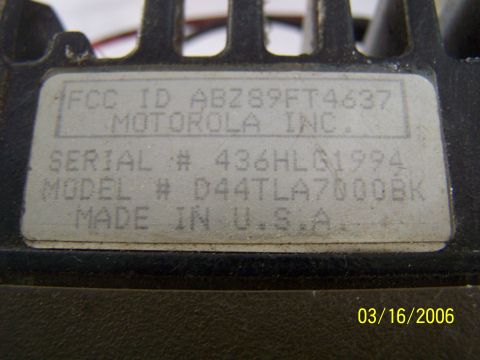 1998 Ford Crown Victoria - A label on a Motorola device displays its FCC ID, serial number, and model number, along with 'Made in U.S.A.'.