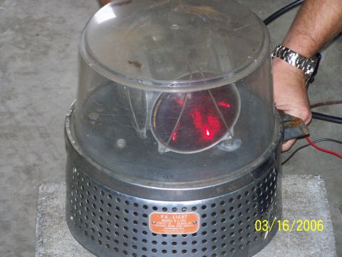 1998 Ford Crown Victoria - A rotating beacon light with a clear dome, red lens, and perforated metal base is shown, with a date stamp of 03/16/2006 visible.